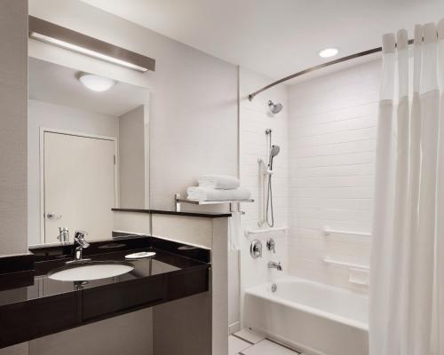 a bathroom with a sink and a tub and a toilet at Fairfield Inn & Suites by Marriott El Paso Airport in El Paso