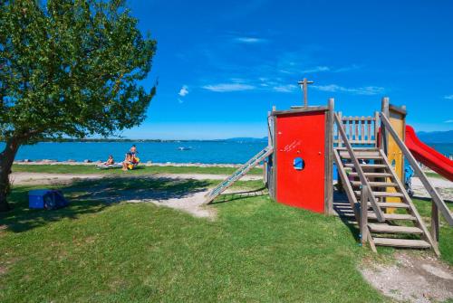 a playground with a slide on the beach at Campeggio del Garda in Peschiera del Garda