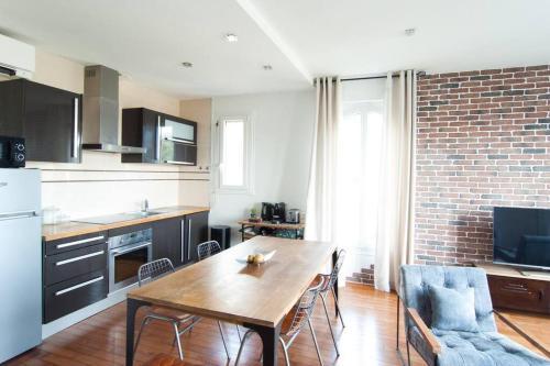 a kitchen with a wooden table and a dining room at Cozy 1 bedroom flat,free parking, close to center in Cannes