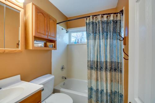 a bathroom with a toilet and a shower curtain at Prescott A-Frame with Deck - 12 Mi to Lynx Lake! in Prescott