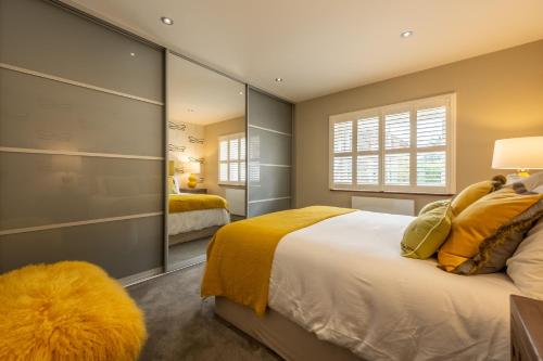 a bedroom with a large bed and a large mirror at Pinchen House in South Creake