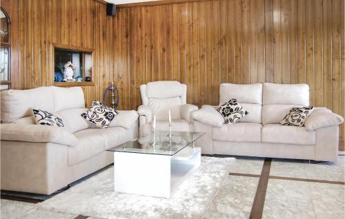 a living room with two couches and a coffee table at 3 Bedroom Awesome Home In Antromero in Candás