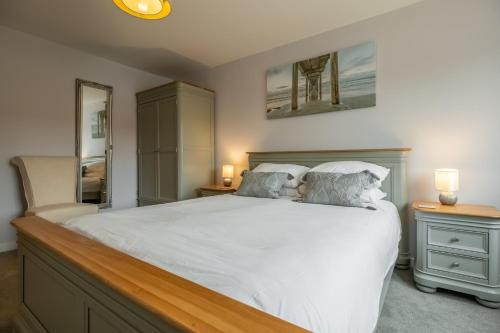 a bedroom with a white bed with two pillows at Field View in Sedgeford