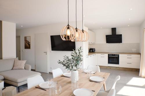 a kitchen and living room with a table and chairs at SKAN-PARK Ferienhäuser & Tiny Houses am Bärwalder See in Jahmen Ausbau