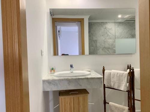 a bathroom with a sink and a mirror at Penthouse Arenal Playa in Marbella