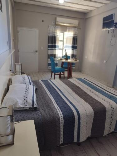 sypialnia z dużym łóżkiem i niebieskim krzesłem w obiekcie Alojamiento temporario w mieście Formosa