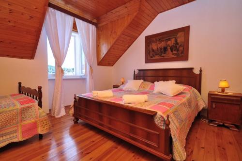a bedroom with two beds and a large window at Holiday home Gariful in Milna