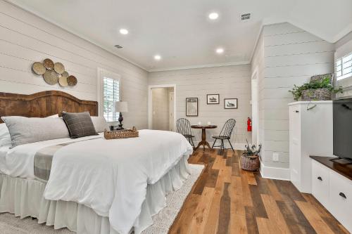 Un dormitorio blanco con una cama grande y una mesa en The Cottages at Laurel Brooke, en Peachtree City