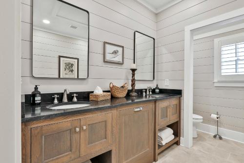 a bathroom with a sink and a mirror at The Cottages at Laurel Brooke in Peachtree City