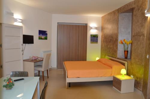 a bedroom with a bed and a desk in a room at La Stella di Gallipoli in Gallipoli