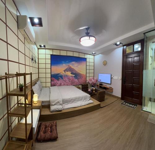 a bedroom with a large painting on the wall at Sunflower Homestay Hai Phong in Hai Phong