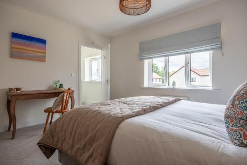 Ένα ή περισσότερα κρεβάτια σε δωμάτιο στο Sandpiper House 4