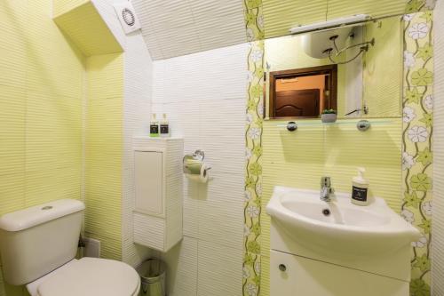 a bathroom with a white toilet and a sink at Quiet & Modern Maisonette in Varna City