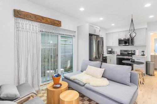 a living room with a couch and a kitchen at The Sweetest Suite - 91 Walkscore! in Seattle