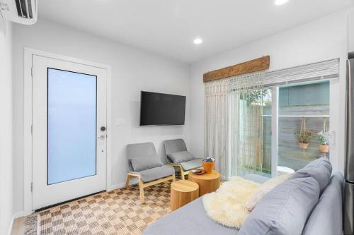 a living room with a couch and a window at The Sweetest Suite - 91 Walkscore! in Seattle