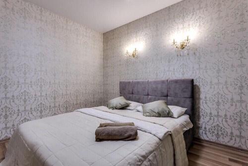 a bedroom with a bed with a pillow on it at Viktoria Garden apartment in Lviv