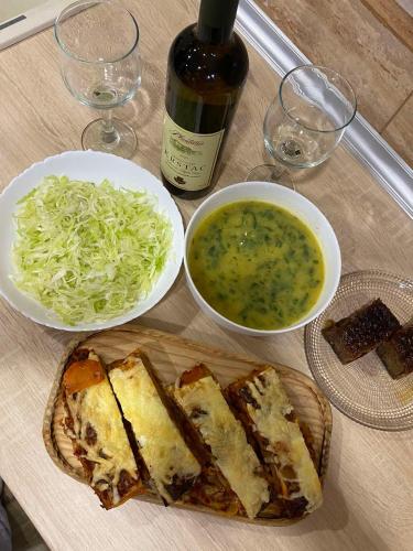 a table with two plates of sandwiches and a bowl of soup at Ethno village & resort Ćorić in Mojkovac