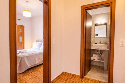 a door leading to a bedroom with a bed at Enalia Suites in Amoopi