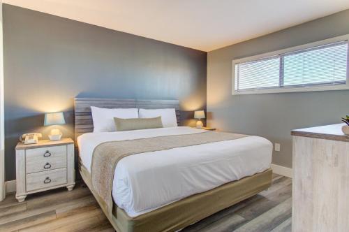 a bedroom with a large bed and a window at 0703 Atlantic Retreat by Atlantic Towers in Carolina Beach