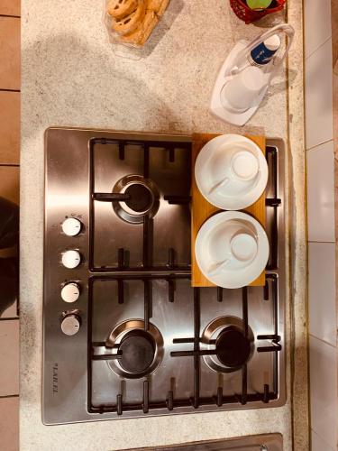 a stove top with pots and pans on a counter at La Candida Rosa L T Anagni in Anagni