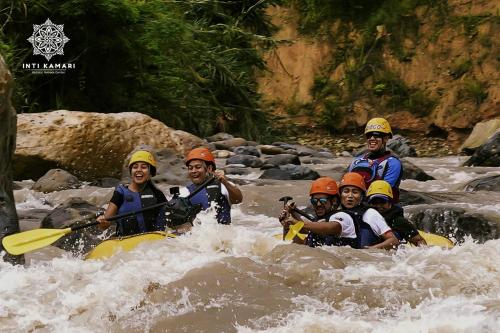 a group of people in a raft in a river at Inti Kamari Wellness Lodge & Convention Center in Santa Isabel