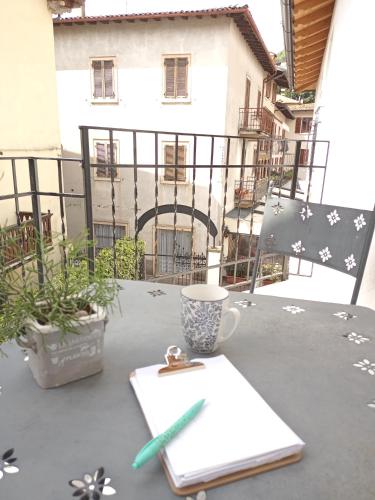 a table with a cup of coffee on a balcony at appartamenti Residenza 1928 in Tremosine Sul Garda