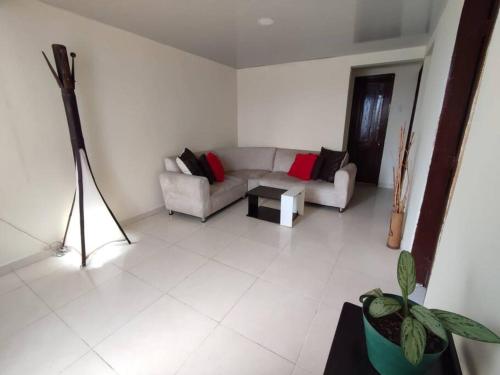 a living room with a couch and a table at Lugar acogedor, Ideal para estar en familia. in Santa Rosa de Cabal