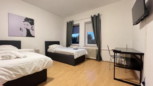 1 dormitorio con 2 camas y ventana en Central Apartments - Work&Stay, en Neumünster