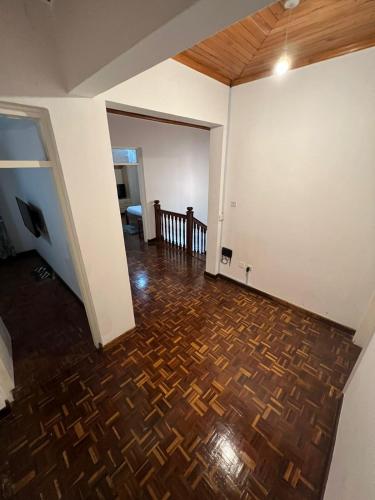 an empty living room with a wooden floor at El Tessa garden/serviced apartment in Kisumu