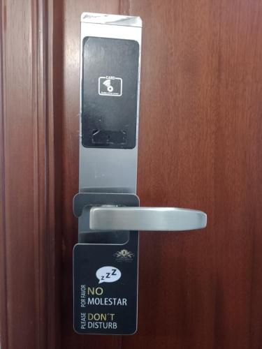 a cell phone is hooked up to a door at Hotel Boutique Quinta Camacho in Bogotá