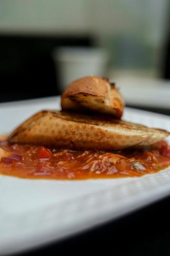 a plate of food with a banana and sauce at El Tessa garden/serviced apartment in Kisumu