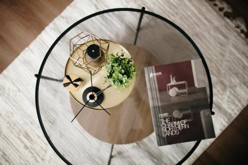 two donuts on a glass table with a book at VIP apartments Bitola in Bitola