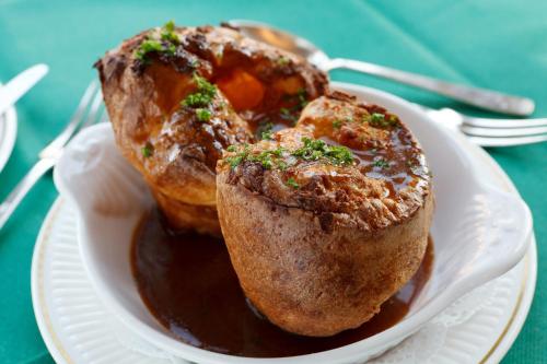 two muffins on a plate on a table at Saxonville Hotel in Whitby