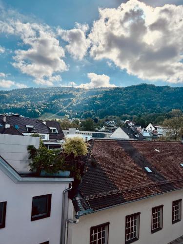 a view of a town with houses and a kite in the sky at Penthouse im Zentrum von Bregenz in Bregenz