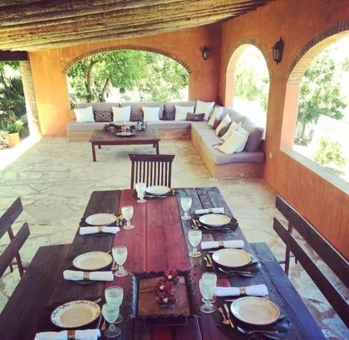 a wooden table in a living room with a couch at Herdade da Negrita in Santo Aleixo