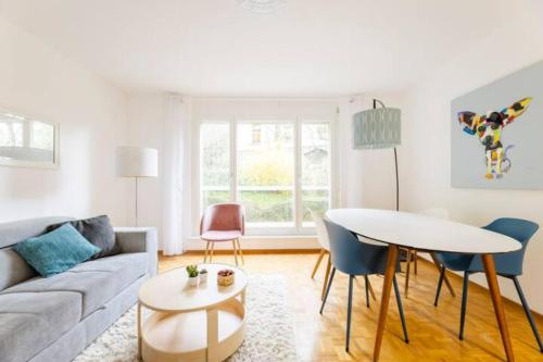 a living room with a couch and a table at Apartment of 52 sqm with free parking in Lausanne