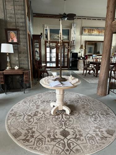 a living room with a table on a rug at The Purple Martin Lakeside Inn Bird Sanctuary on Lake Huron in Rogers City