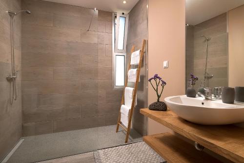 a bathroom with a sink and a shower at Villa da Silva (Heated Pool and Private Parking) in Arco da Calheta