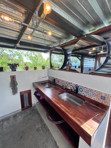 a bathroom with a sink and a mirror at El Filito in San JosÃ©