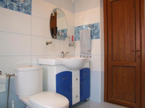 a bathroom with a toilet and a sink at Hotel Central in Jermuk