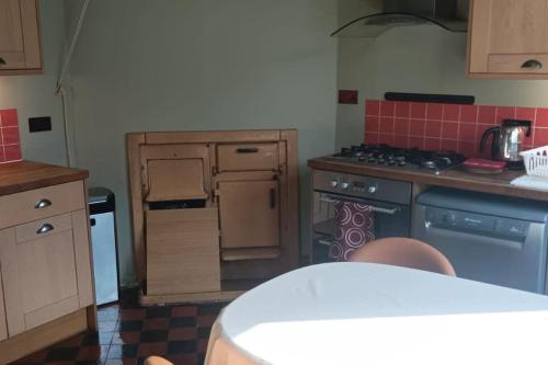 a kitchen with a stove top oven next to a counter at Ruskin Square, Sheffield in Heeley