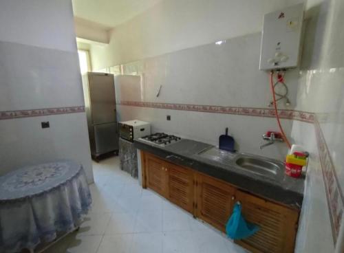 a kitchen with a sink and a stove at Residence Ray in Fez