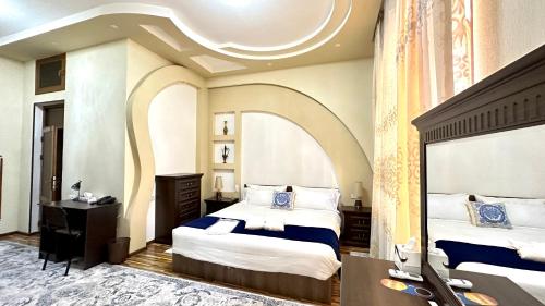 a bedroom with two beds and a coffered ceiling at Boutique Hotel Mosaic in Samarkand