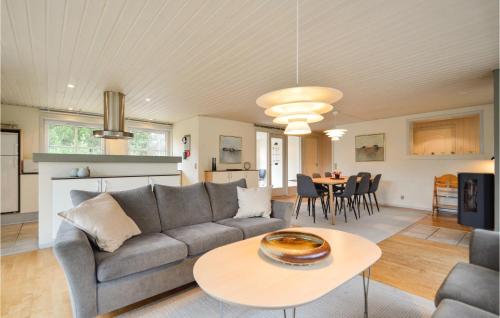 a living room with a couch and a table at Holiday Home Umanaksvej Rømø Denm in Bolilmark