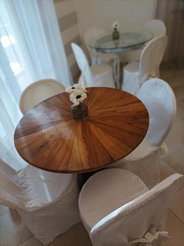 a wooden table with white chairs around it at La Sosta in Lunigiana in Monti di Licciana Nardi