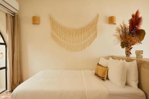 a bedroom with a bed with white sheets and pillows at DUNA by DW in San Juan