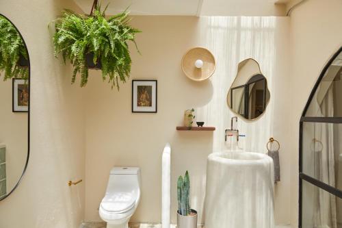 a bathroom with a sink and a toilet and a mirror at DUNA by DW in San Juan