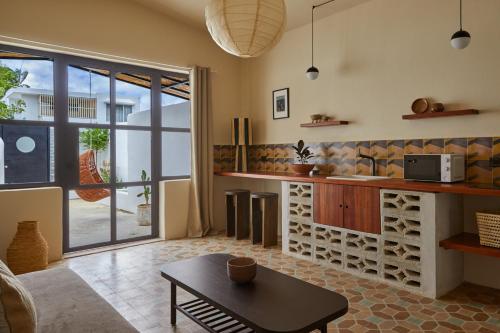 a living room with a kitchen and a table at DUNA by DW in San Juan