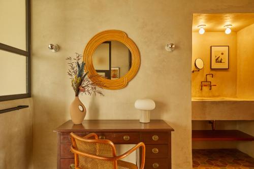 a dressing room with a mirror and a wooden dresser at DUNA by DW in San Juan