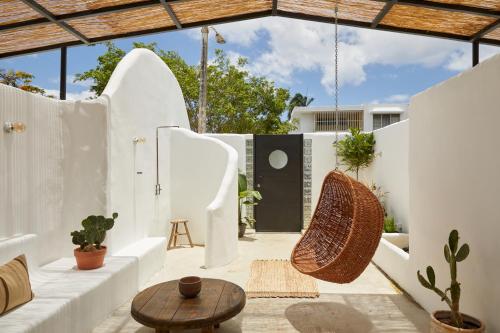 a patio with white walls and a table and chairs at DUNA by DW in San Juan